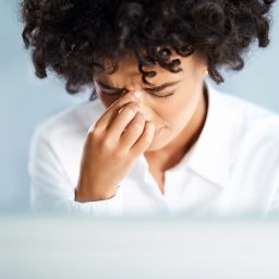 Woman experiencing sinus pressure from allergies